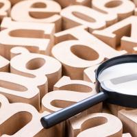 magnifying lens on top of wood letters