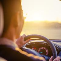 A man behind the wheel of a car