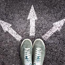 Tennis shoes with chalk arrows pointing away from them