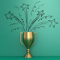 Trophy cup with stars drawn as if they are exploding out of it